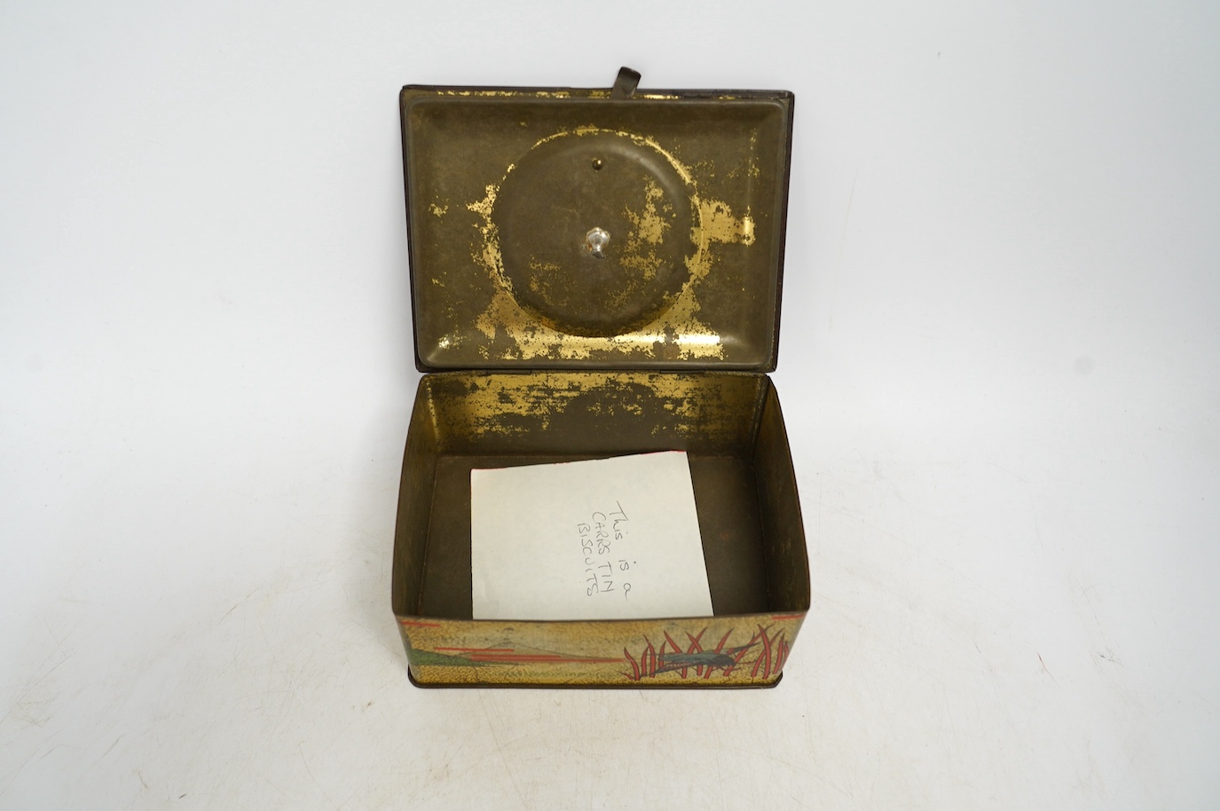 An early 20th century Carrs novelty 'dice game' biscuit tin, a Don Confectionery 'chessboard' tin and a Wright & Son Ltd inkstand tin, largest 33cm wide. Condition - fair